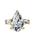 The 14K Yellow Gold 3-Stone Baguette East/West Side Stones 0.25TCW Engagement Ring features a pear-shaped center diamond with two baguette-cut side stones, shown against a plain white background.