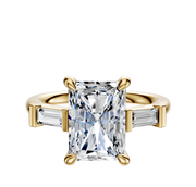 The 14K Yellow Gold 3-Stone Baguette East/West Side Stones 0.125TCW Engagement Ring features a rectangular-cut center stone and two smaller baguette side stones, set against a plain white background.