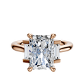 The 18K Rose Gold 3-Stone Baguette Side Stones Set North/South 0.125TCW Ring features a central diamond accented by two rectangular baguette side stones, set on a polished rose gold band against a plain white background.