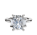 The Platinum 3-Stone Baguette Side Stones Set North/South 0.125TCW Ring features a central diamond flanked by two baguette side stones, all set on a simple, polished platinum band.