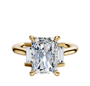 The 14K Yellow Gold 3-Stone Baguette Side Stones Set North/South 0.125TCW Ring features a large central gemstone with two smaller rectangular baguette gemstones on each side.