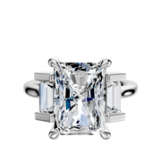 A 14K white gold 3-stone engagement ring featuring a north/south set center and baguette side stones totaling 0.25 TCW, displayed on a plain white background.