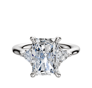 The Platinum 3-Stone Trillion Side Stones 0.125TCW Engagement Ring showcases a central radiant-cut diamond with two triangular side stones, set in platinum and displayed on a plain white background.