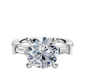 The 18K White Gold 3-Stone Baguette East/West Side Stones 0.125TCW Engagement Ring features a prominent center stone flanked by rectangular baguette side stones, set in prongs against a plain white background.