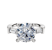 The Platinum 3-Stone Baguette East/West Side Stones 0.125TCW Engagement Ring features a central diamond with two baguette-cut side stones, displayed on a plain white background.
