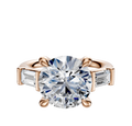The 14K Rose Gold 3-Stone Baguette East/West Side Stones 0.25TCW Engagement Ring features a central round diamond flanked by two rectangular baguette diamonds in a four-prong setting, shown on a white background.