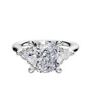 A 14K white gold engagement ring featuring three stones with a central diamond and two pear-shaped side diamonds totaling 0.125TCW, displayed on a plain white background.