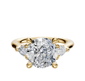 The 18K Yellow Gold 3-Stone Pear Side Stones 0.125TCW Engagement Ring features a large center diamond with two pear-shaped side diamonds, set on a polished gold band.