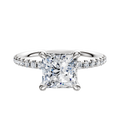 A 14K white gold engagement ring with a 4-prong basket setting, classic dome design, and a 2.5mm band accented by a single row of pave-set diamonds.