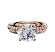 A 14K rose gold engagement ring featuring a classic knife-edge band, a four-prong basket setting for the center diamond, and a single row of pave-set diamonds along each side.