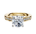 The 14K Two Tone 4 Prong Hidden Halo Classic Flat 1-Row-Pave 2.5mm Engagement Ring features a round-cut center diamond in a prong setting with smaller diamonds set along the band for added brilliance.