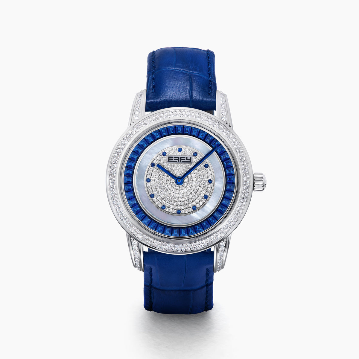 The 38MM Swiss Made Stainless Steel watch features a diamond-encrusted silver case, blue topaz hour markers, textured silver geometric dial with the EAFY logo, and a blue leather strap for a luxurious finish.