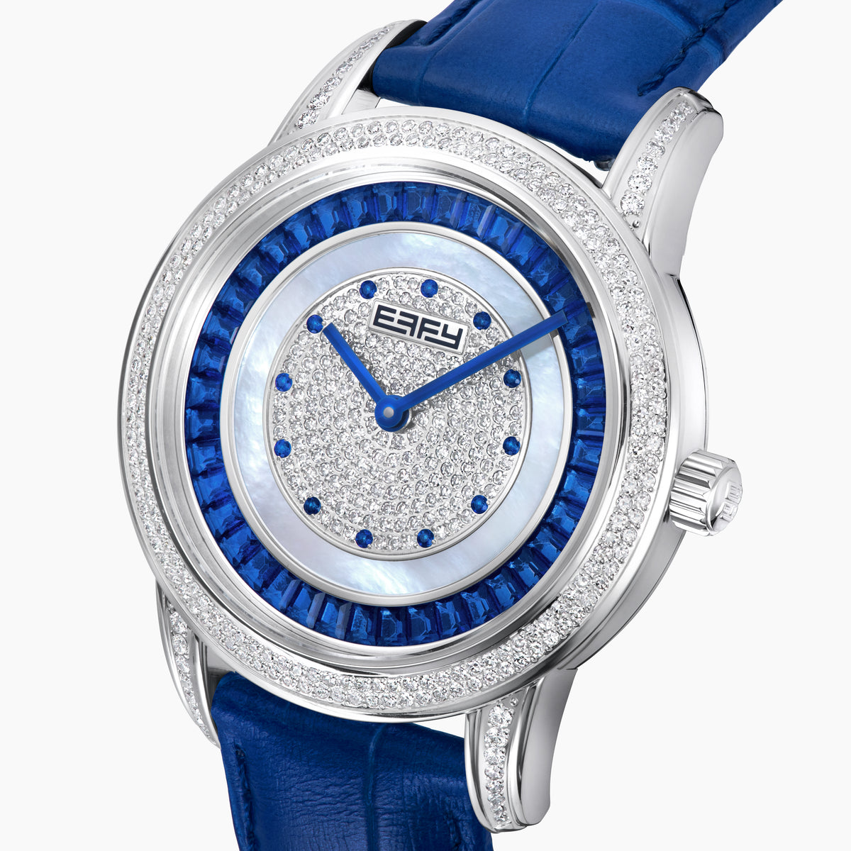 The 38MM Swiss Made Stainless Steel watch features a diamond-encrusted silver case, blue topaz hour markers, textured silver geometric dial with the EAFY logo, and a blue leather strap for a luxurious finish.