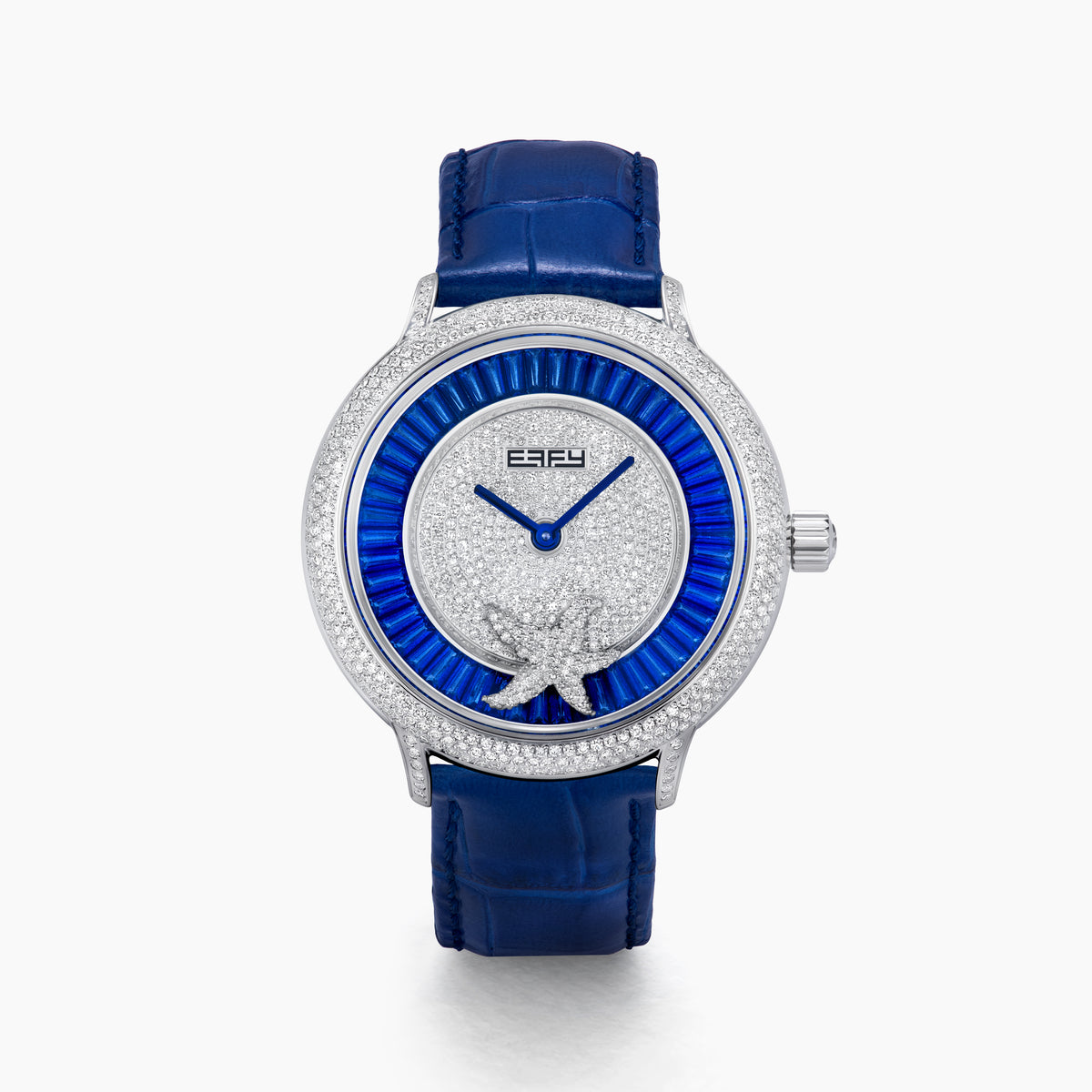 The 38MM Swiss Made Stainless Steel Spinning Starfish Watch features diamonds, blue topaz, a blue leather strap, silver face with blue accents, silver hands, the EARY logo on the dial, and a jeweled starfish motif near the bottom.