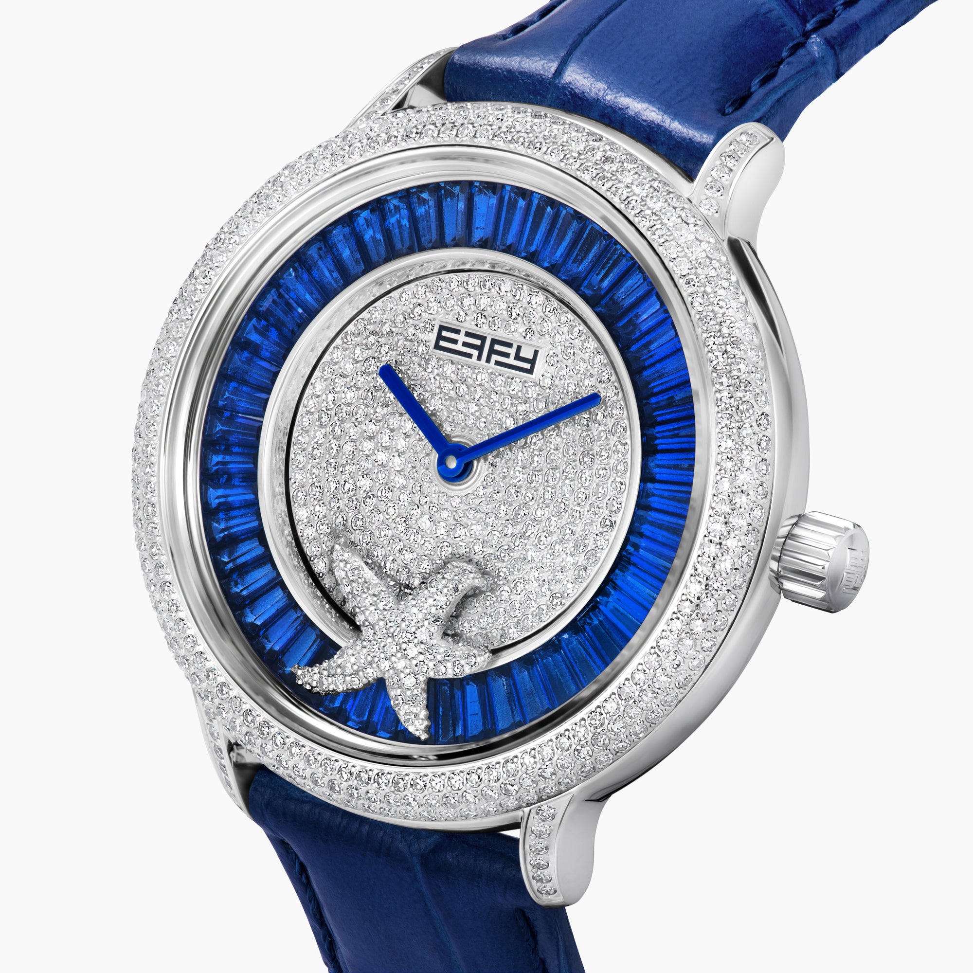 The 38MM Swiss Made Stainless Steel Spinning Starfish Watch features diamonds, blue topaz, a blue leather strap, silver face with blue accents, silver hands, the EARY logo on the dial, and a jeweled starfish motif near the bottom.