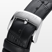 The 39MM Swiss Made Stainless Steel Signature Panther Watch with Diamonds features a black leather strap, diamond-encrusted bezel, and a dial adorned with a detailed panther head crafted from black and colored gemstones.
