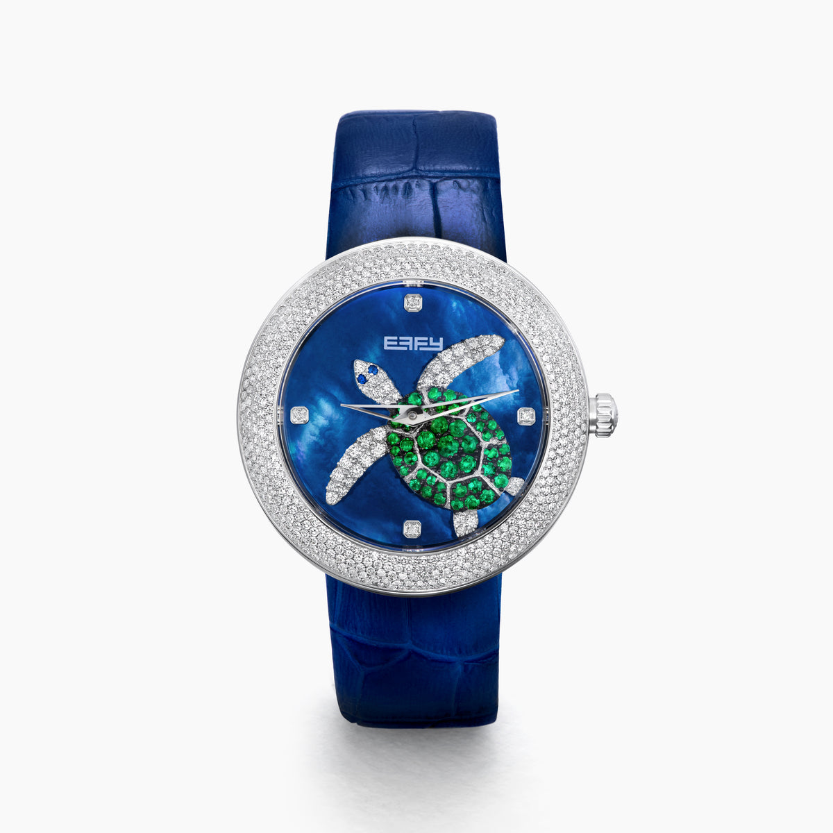 The 39MM Swiss Made Stainless Steel Turtle Watch features diamonds, sapphires, and tsavorite. It has a blue strap and dial, jeweled turtle motif in green and white stones, a diamond-encrusted silver bezel, and EFFY branding on the face.