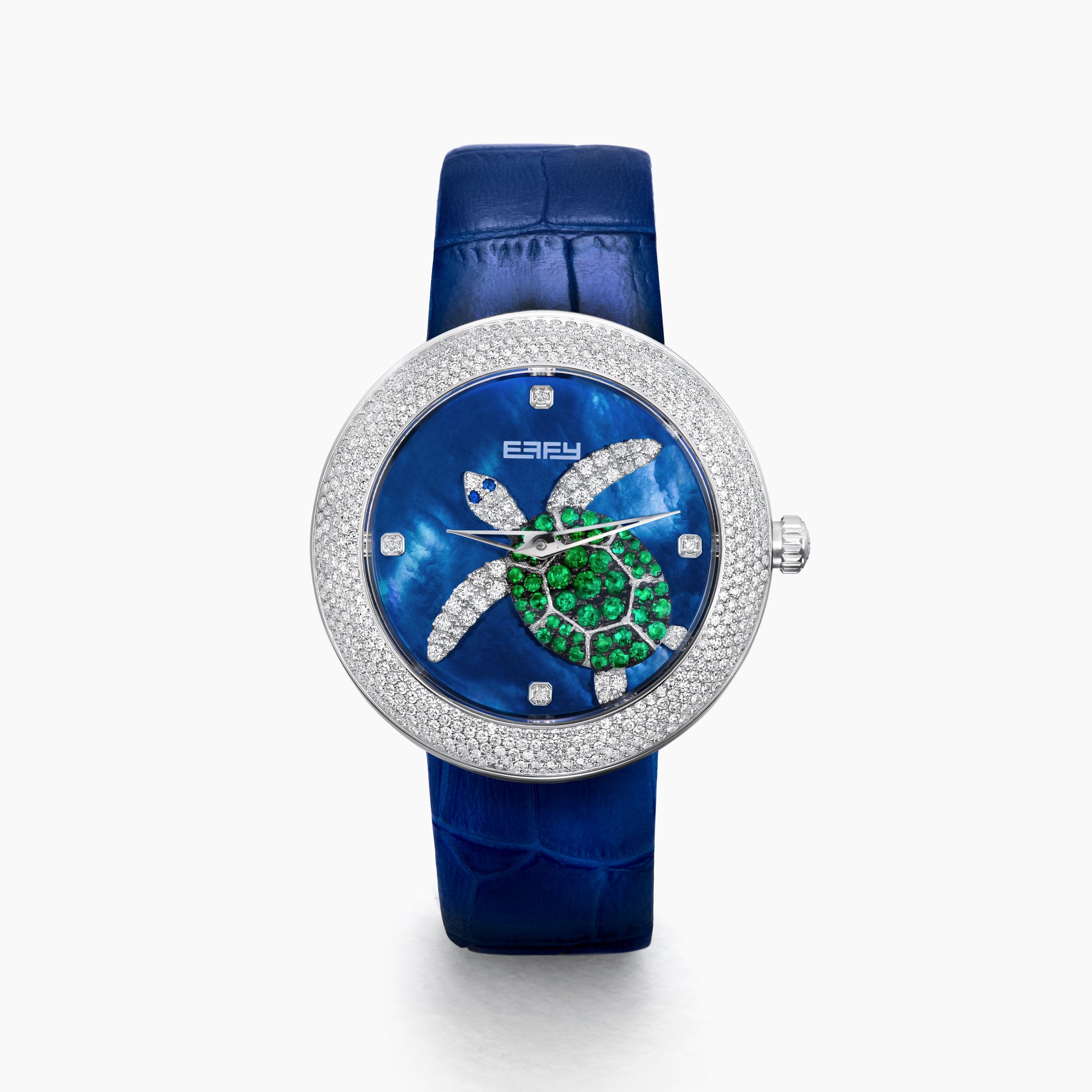 The 39MM Swiss Made Stainless Steel Turtle Watch features diamonds, sapphires, and tsavorite. It has a blue strap and dial, jeweled turtle motif in green and white stones, a diamond-encrusted silver bezel, and EFFY branding on the face.