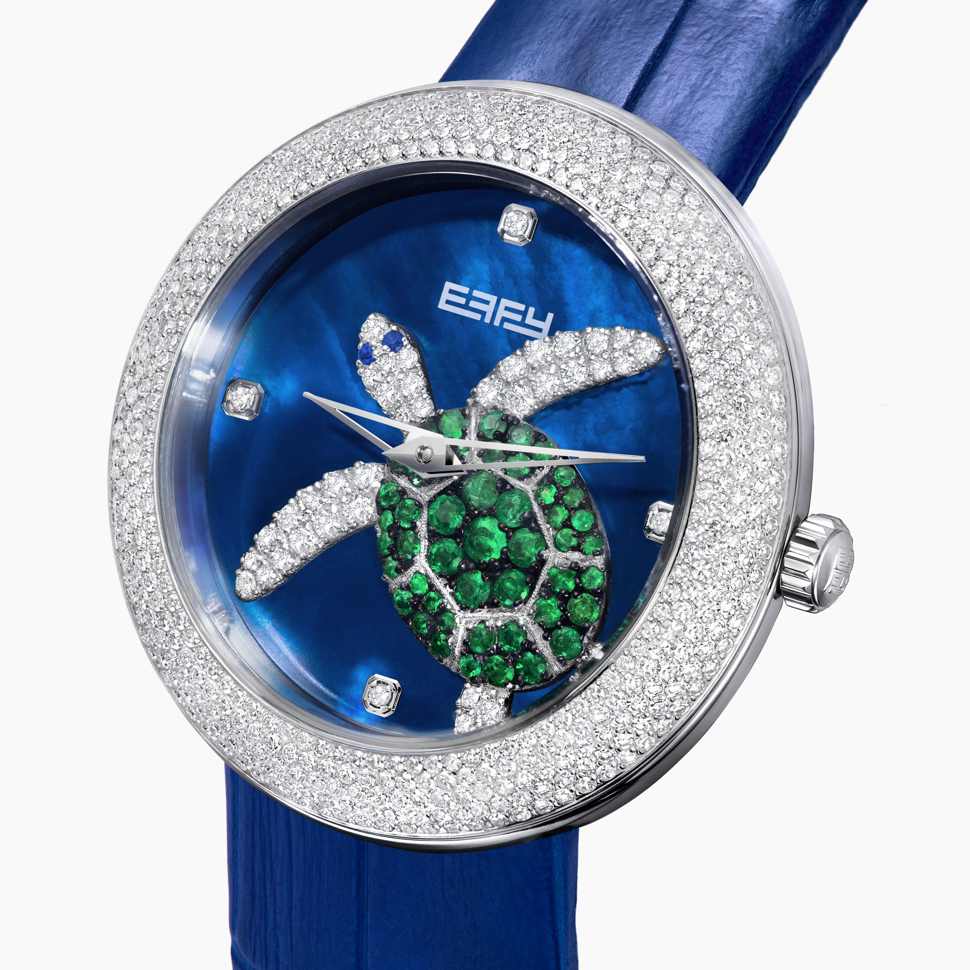 The 39MM Swiss Made Stainless Steel Turtle Watch features diamonds, sapphires, and tsavorite. It has a blue strap and dial, jeweled turtle motif in green and white stones, a diamond-encrusted silver bezel, and EFFY branding on the face.