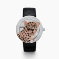 The 39MM Swiss Made Stainless Steel Signature Panther Watch with Diamonds features a jeweled panther design on the dial, gold and diamond accents, green gemstone eyes, and a black leather strap.
