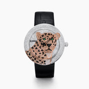 The 39MM Swiss Made Stainless Steel Signature Panther Watch with Diamonds features a jeweled panther design on the dial, gold and diamond accents, green gemstone eyes, and a black leather strap.