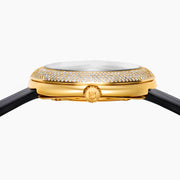 The 39MM Swiss Made 18K Yellow Gold Signature Round Panther Watch with Diamonds features a jeweled panther face on a glossy black dial, green eyes, gold hands, and a diamond-encrusted bezel with a black leather strap for luxurious elegance.