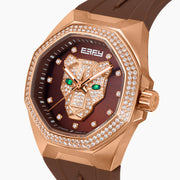 Experience the elegance of the 38MM Swiss Made 18K Rose Gold Signature Panther Automatic Watch with Diamond Bezel, showcasing a sophisticated brown strap, an 18K rose gold-tone case adorned with diamond accents, and a dazzling diamond pavé panther motif on the dial with captivating green gemstone eyes and the distinctive EARLY branding at the top.