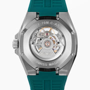 The 42MM Swiss Made Stainless Steel Automatic Skeleton Watch with Diamonds features a teal rubber strap, silver case, partially transparent dial with visible gears, teal bezel and markings, and EBFY branding at the top.