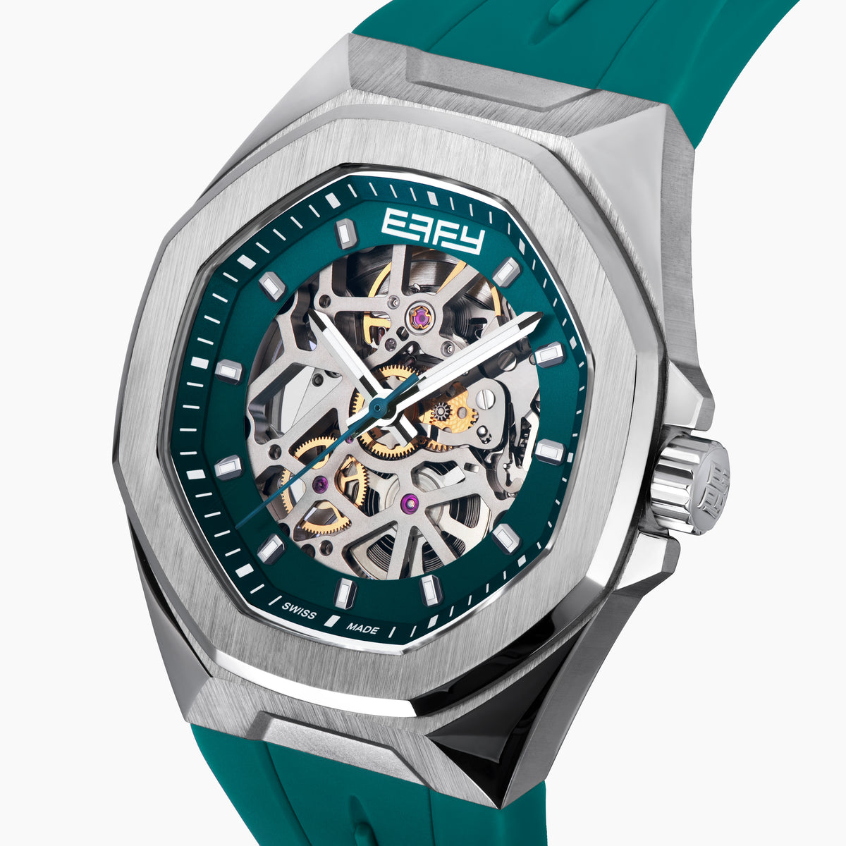 The 42MM Swiss Made Stainless Steel Automatic Skeleton Watch with Diamonds features a teal rubber strap, silver case, partially transparent dial with visible gears, teal bezel and markings, and EBFY branding at the top.