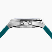 The 42MM Swiss Made Stainless Steel Automatic Skeleton Watch with Diamonds features a teal rubber strap, silver case, partially transparent dial with visible gears, teal bezel and markings, and EBFY branding at the top.