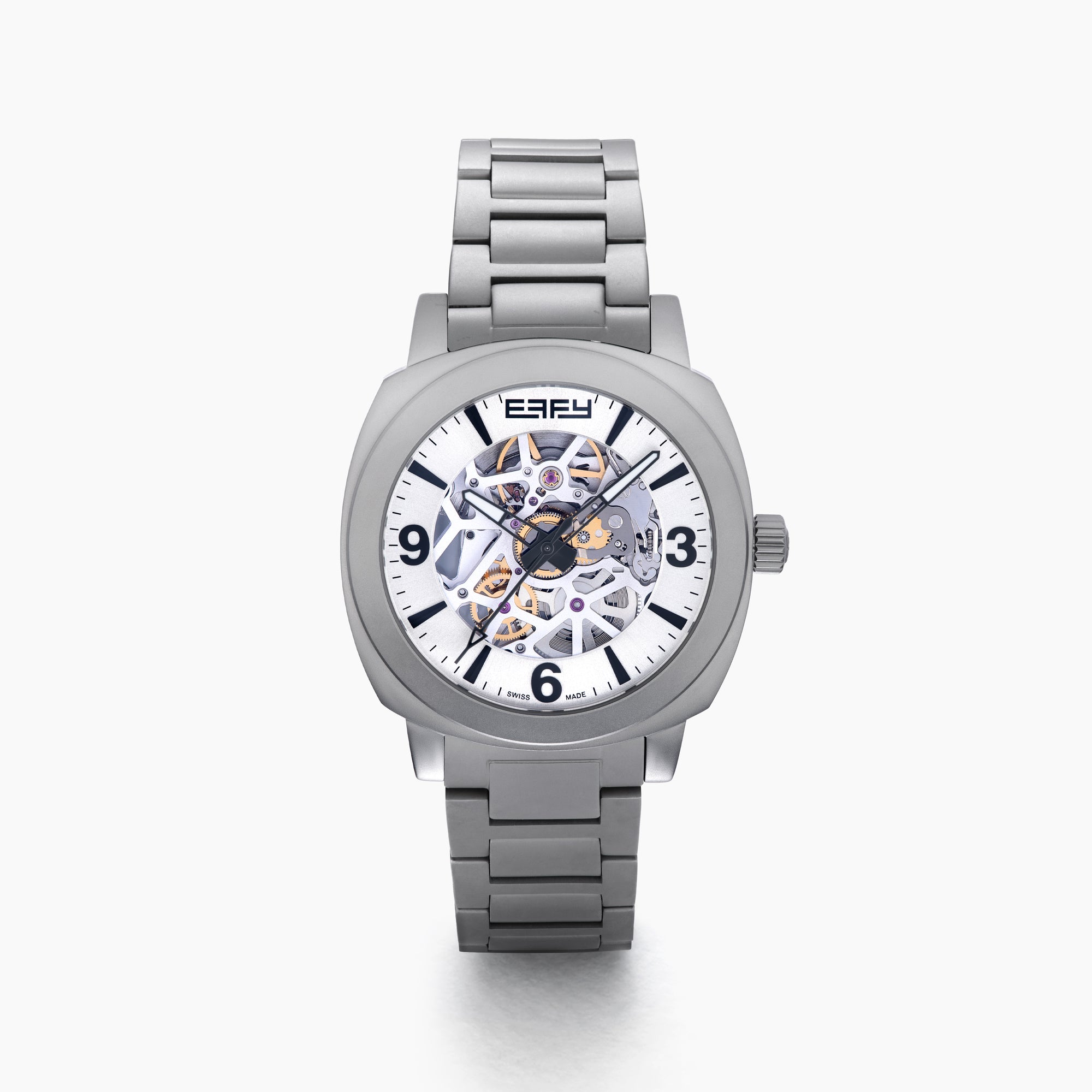 The 41MM Swiss Made Stainless Steel Automatic Skeleton Watch features a silver metal band, white face, black hour markers, and an open skeleton dial displaying inner gears. "ESPY" is printed below the 12 o’clock position.