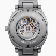 The 41MM Swiss Made Stainless Steel Automatic Skeleton Watch features a silver metal band, white face, black hour markers, and an open skeleton dial displaying inner gears. "ESPY" is printed below the 12 o’clock position.