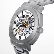 The 41MM Swiss Made Stainless Steel Automatic Skeleton Watch features a silver metal band, white face, black hour markers, and an open skeleton dial displaying inner gears. "ESPY" is printed below the 12 o’clock position.