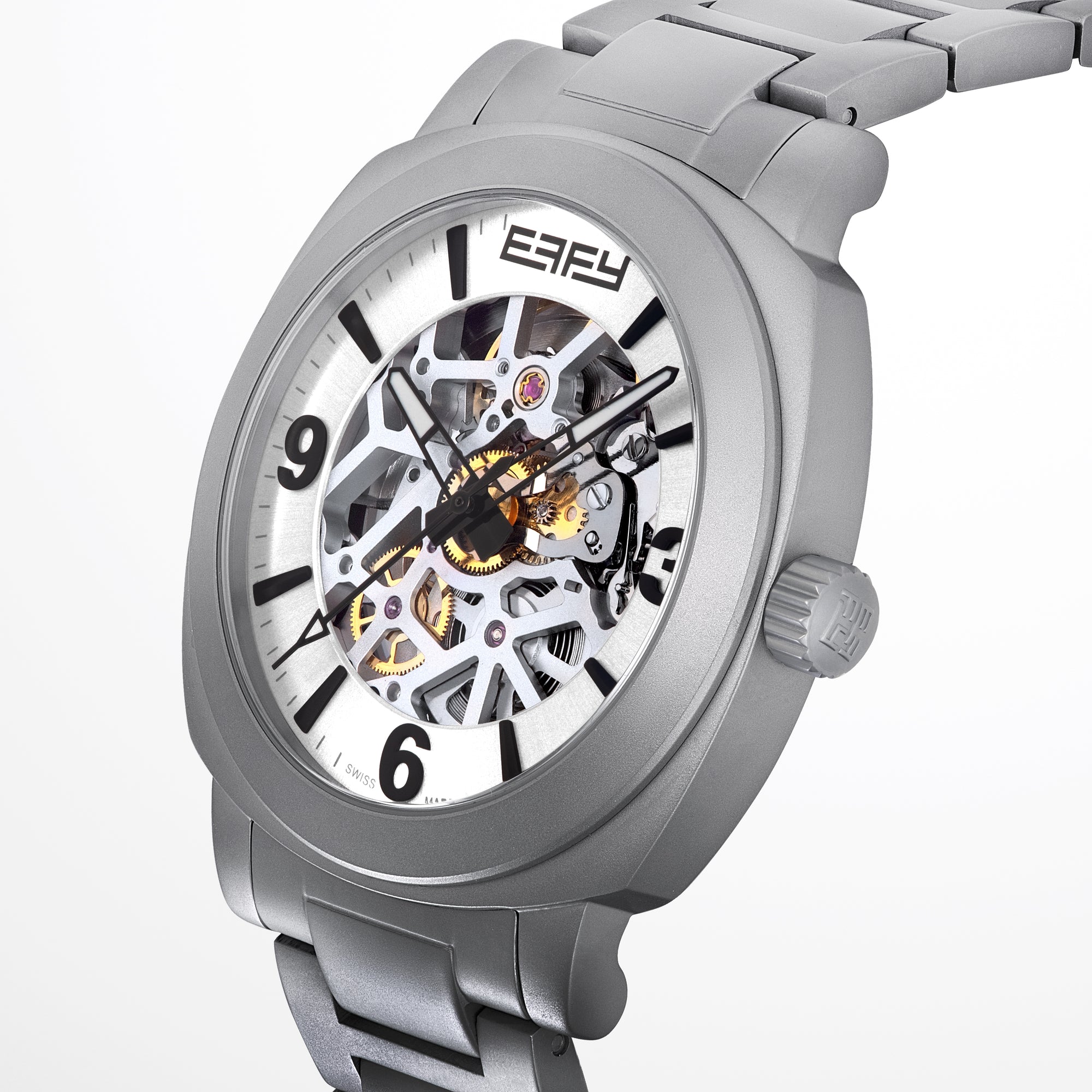 The 41MM Swiss Made Stainless Steel Automatic Skeleton Watch features a silver metal band, white face, black hour markers, and an open skeleton dial displaying inner gears. "ESPY" is printed below the 12 o’clock position.