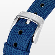 The 28MM Swiss Made Stainless Steel Cocktail Watch features a luxurious oval design with a diamond and blue sapphire-studded face, silver hands, deep blue textured leather strap, and exquisite Swiss craftsmanship.