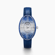 The 28MM Swiss Made Stainless Steel Cocktail Watch features a luxurious oval design with a diamond and blue sapphire-studded face, silver hands, deep blue textured leather strap, and exquisite Swiss craftsmanship.
