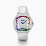 The 39MM Swiss Made Stainless Steel Watch features a white leather strap, mother of pearl dial, diamond-studded face, rainbow sapphire bezel, blue hands, and silver case.
