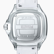 The 39MM Swiss Made Stainless Steel Watch features a white leather strap, mother of pearl dial, diamond-studded face, rainbow sapphire bezel, blue hands, and silver case.
