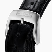 The 39MM Swiss Made Stainless Steel Watch with Diamonds and Black Spinel features a black leather strap, diamond-studded bezel, silver textured dial with blue accents, and bold black hands, shown on a white background.