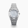A Swiss made timepiece, the 36MM Titanium Watch with Diamonds showcases a silver geometric metal band and a faceted bezel, complemented by a light blue mother-of-pearl dial accented with diamond hour markers.