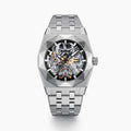 A 42MM Swiss made titanium automatic skeleton watch featuring a geometric bezel that reveals intricate gears and movements beneath the dial, complemented by a metal link bracelet.