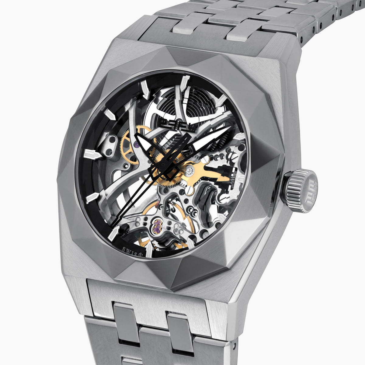 A 42MM Swiss made titanium automatic skeleton watch featuring a geometric bezel that reveals intricate gears and movements beneath the dial, complemented by a metal link bracelet.