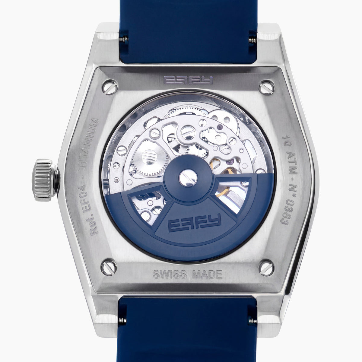 Introducing the 42MM Swiss Made Titanium and Silicone Automatic Skeleton Watch—a luxurious timepiece featuring a geometric silver titanium case and exposed inner mechanisms. Accented with a blue bezel and paired with a blue silicone strap, this design stands out against a white backdrop. Its exceptional clarity and elegance are enhanced by a diamond-cut sapphire crystal.