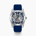 Introducing the 42MM Swiss Made Titanium and Silicone Automatic Skeleton Watch—a luxurious timepiece featuring a geometric silver titanium case and exposed inner mechanisms. Accented with a blue bezel and paired with a blue silicone strap, this design stands out against a white backdrop. Its exceptional clarity and elegance are enhanced by a diamond-cut sapphire crystal.
