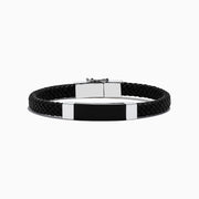 The Mens Sterling Silver and Leather Onyx Bracelet, 12.50 TCW, features a black braided leather band with a rectangular black and silver metal plate and sterling silver clasp, shown on a white background.