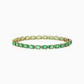 A 14K yellow gold tennis bracelet featuring oval emeralds and diamonds, totaling 9.56 TCW, displayed on a white background.