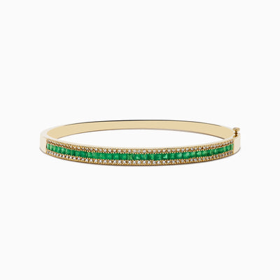 The 14K Yellow Gold Emerald and Diamond Bangle, 2.97 TCW, showcases two dazzling diamond rows and a striking center row of vivid green emeralds for an eye-catching contrast.