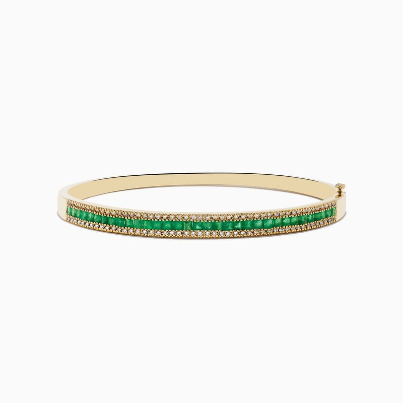 The 14K Yellow Gold Emerald and Diamond Bangle, 2.97 TCW, showcases two dazzling diamond rows and a striking center row of vivid green emeralds for an eye-catching contrast.