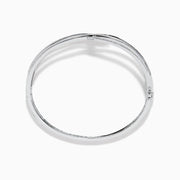 The 14K White Gold Pave Diamond Crisscross Bangle features an open, wavy design adorned with sparkling diamonds along the curves for an elegant, delicate look.
