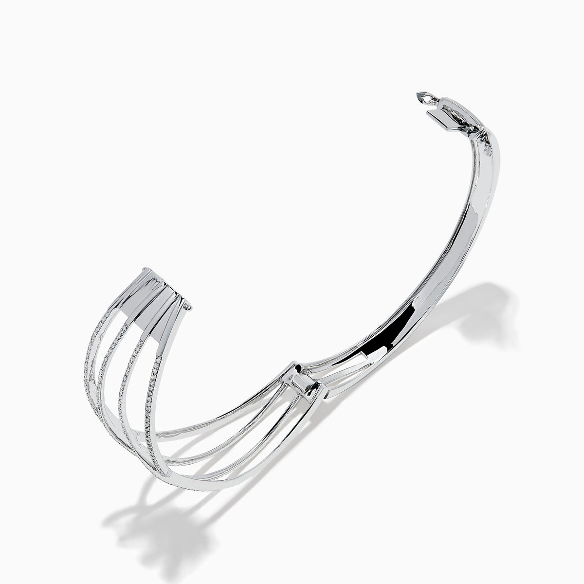 The 14K White Gold Pave Diamond Crisscross Bangle features an open, wavy design adorned with sparkling diamonds along the curves for an elegant, delicate look.